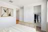 bedroom with white bed, white rug, and oak bed frame
