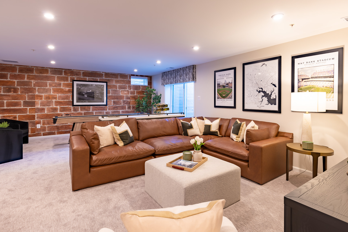basement with a camel colored leather couch