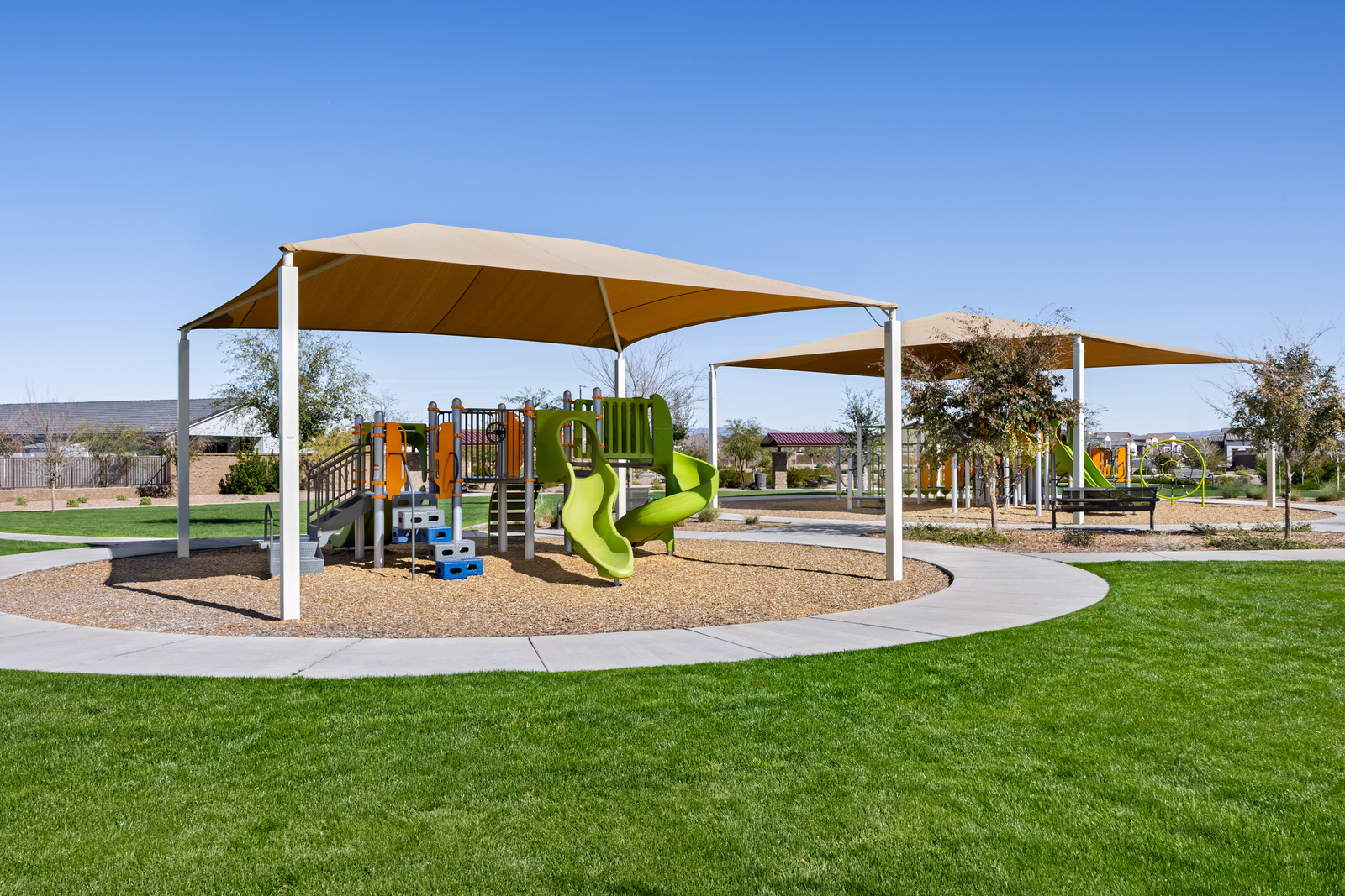 park with green grass and multiple play areas with slides
