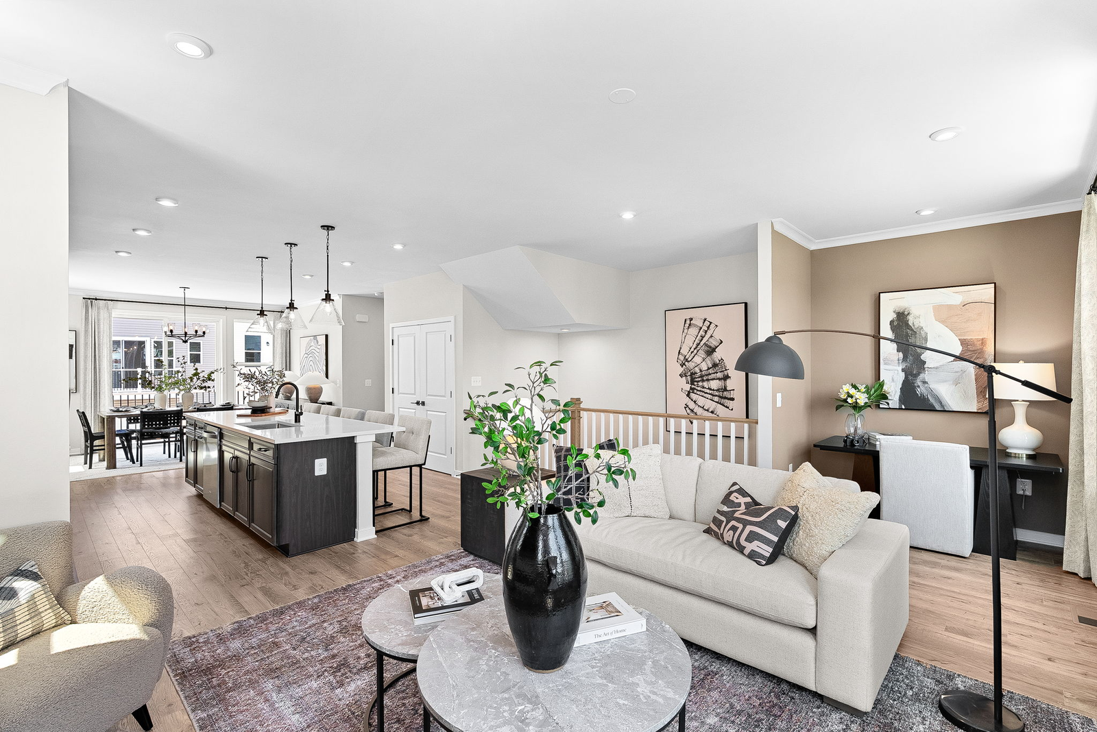 hardwood floors, carpet, sofa and coffee table with view of kitchen and office