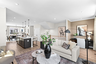hardwood floors, carpet, sofa and coffee table with view of kitchen and office