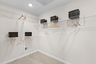 walk in closet with carpet and shelves for clothing