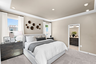 bedroom with carpet, large bed and dresser beside bed