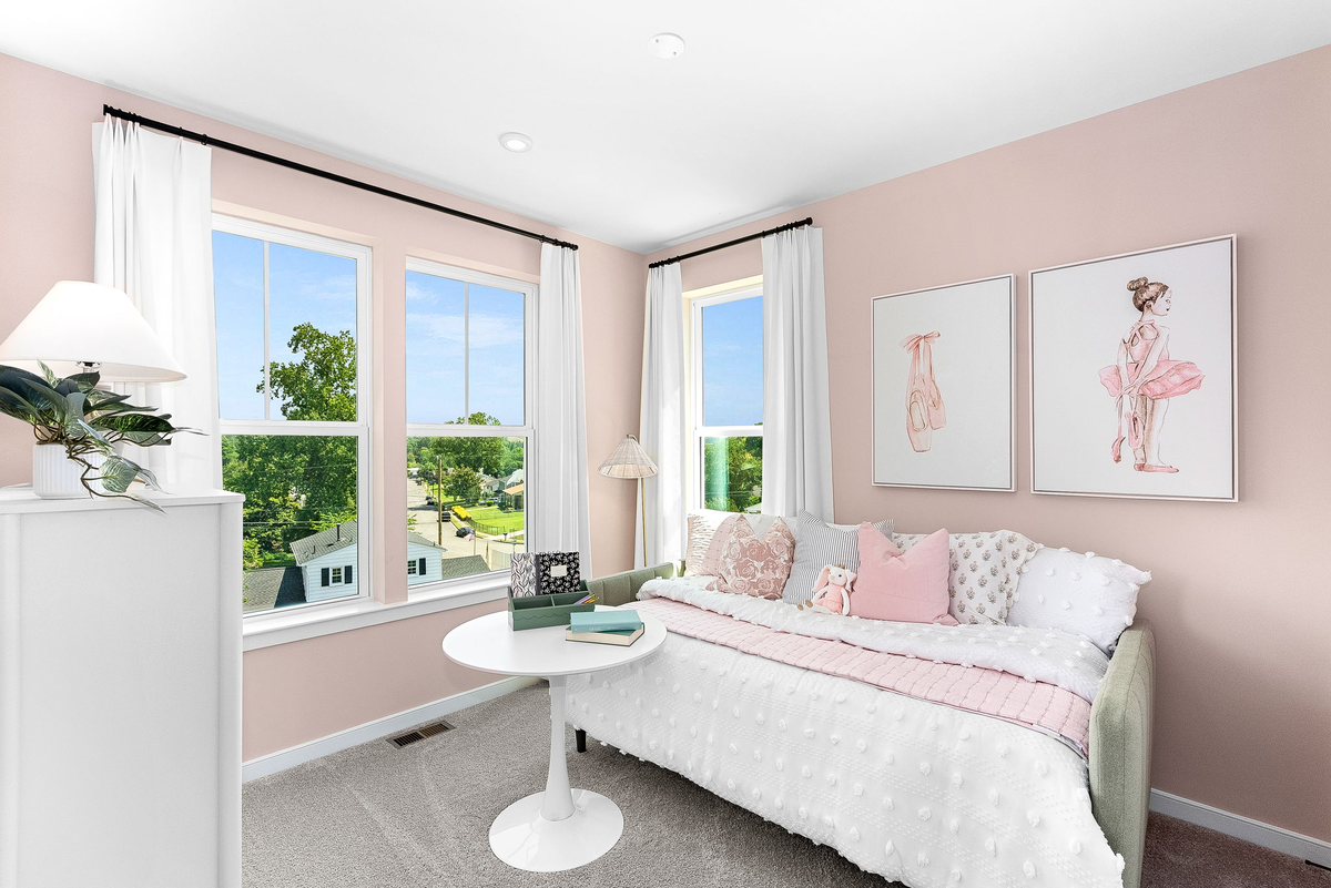 carpeted secondary bedroom with multiple windows