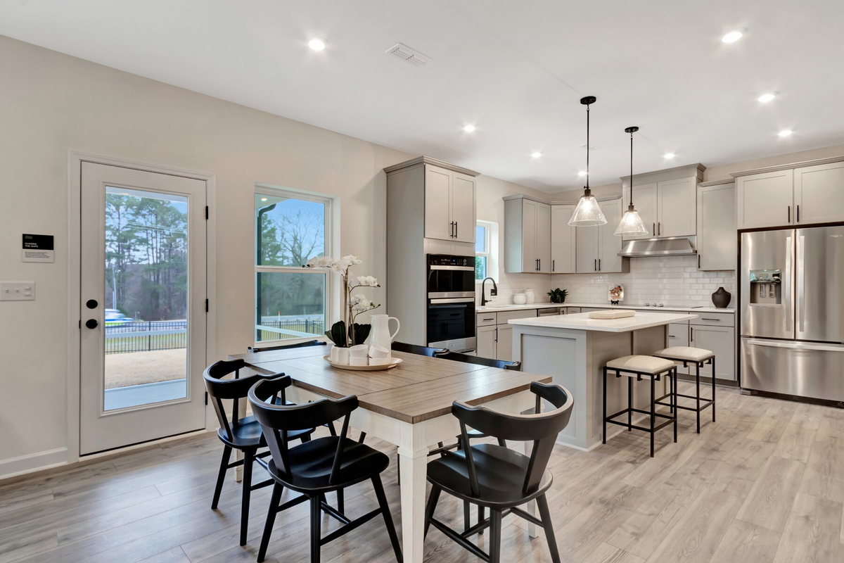 dining area with table next to a kitchen