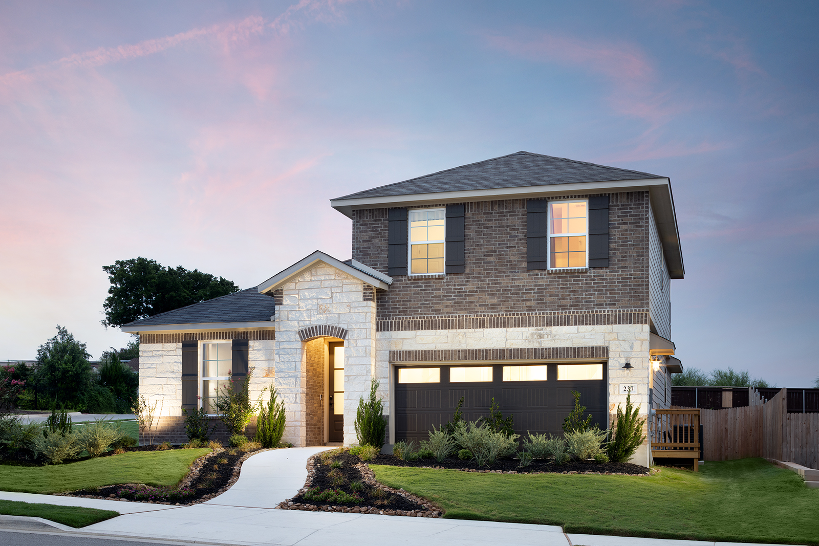 exterior with brick, stone & grass