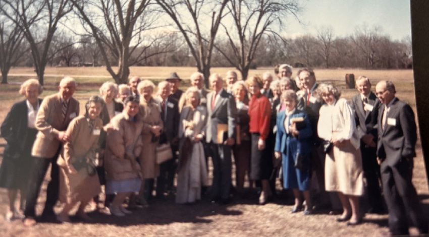 A group of Road Scholars stand with President Jimmy Carter and smile for the camera