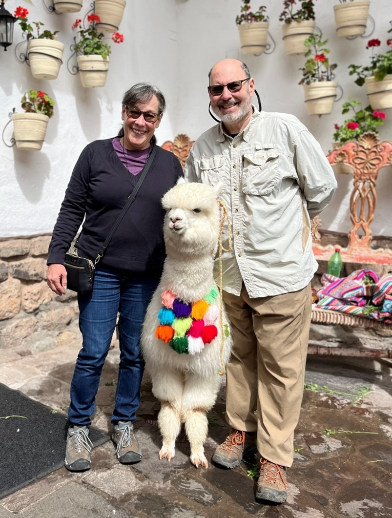 Karen and her husband with an alpaca in Peru