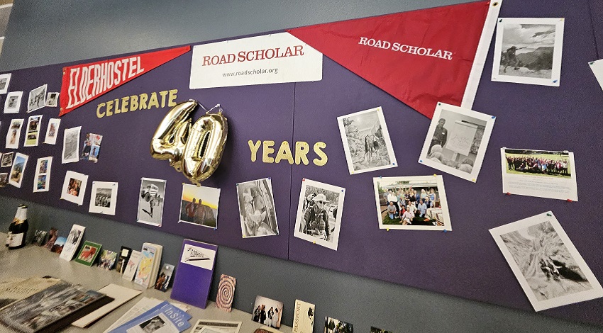 A bulletin board with photos from the history of NAU and Road Scholar