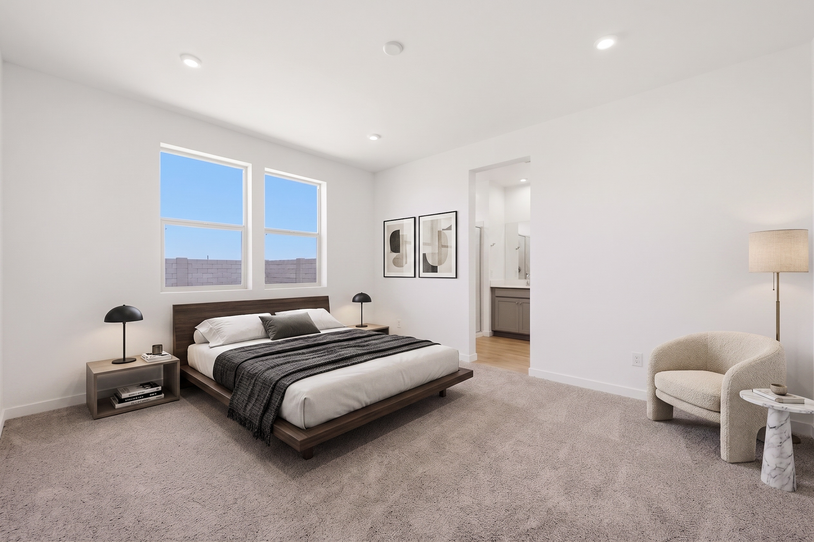 spacious bedroom with a king-sized bed, walnut bedframe, and white accent chair