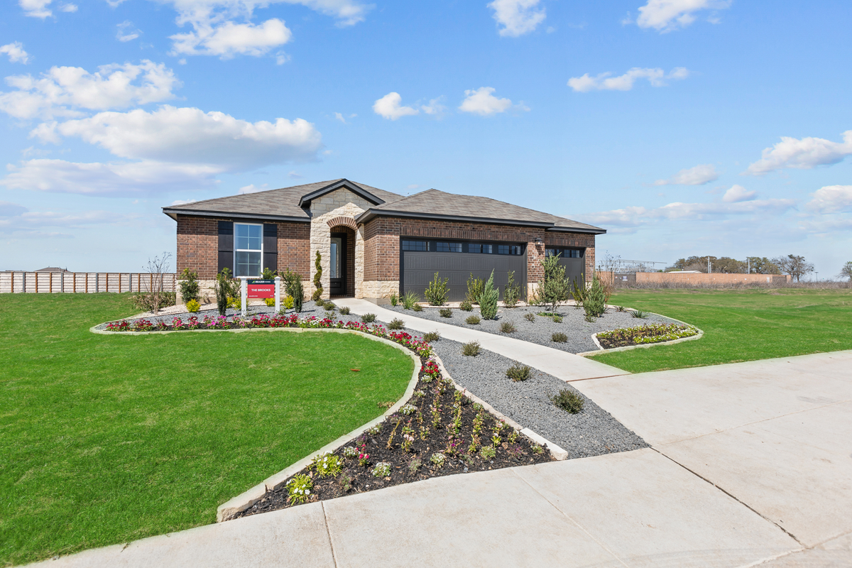 exterior with brick, stone & a 3-car garage 