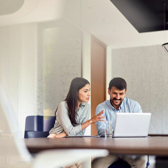Business professionals collaborating with laptop