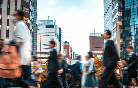 People walking in a cross walk in a city
