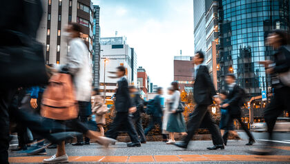 People walking in a cross walk in a city