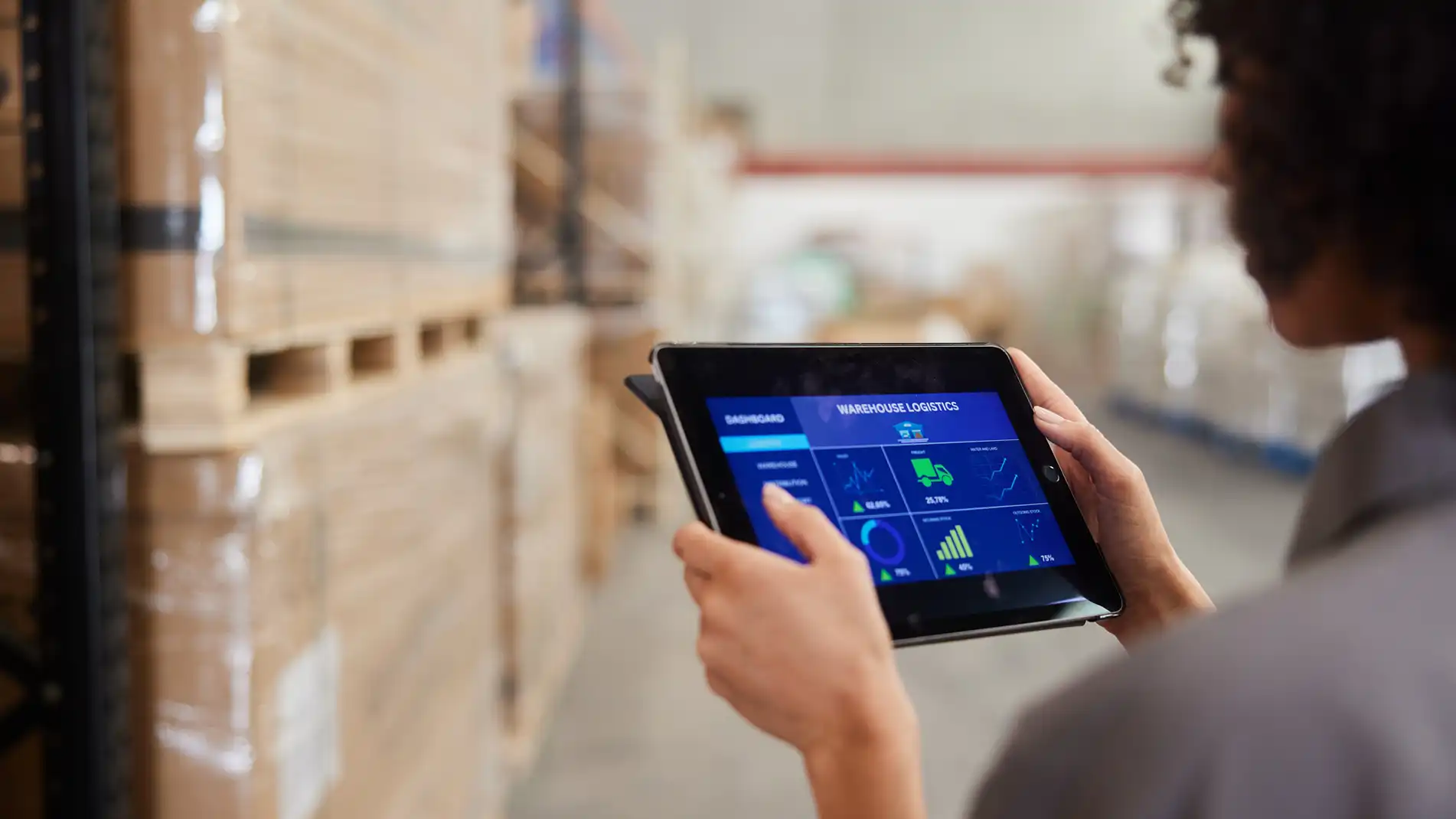Image of a person holding a tablet in their hands.