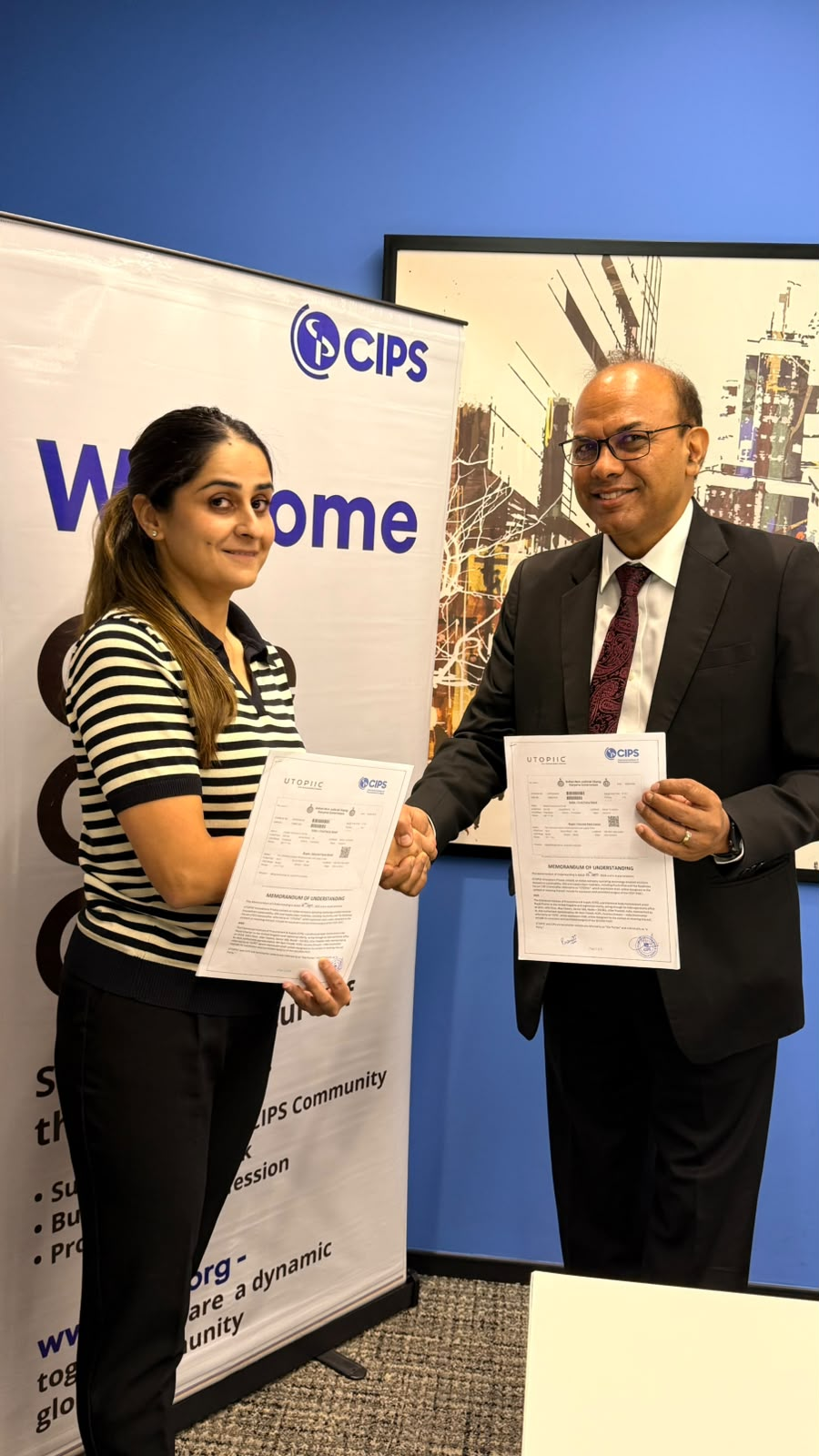 Woman and Man shaking hands holding signed memorandums of understanding
