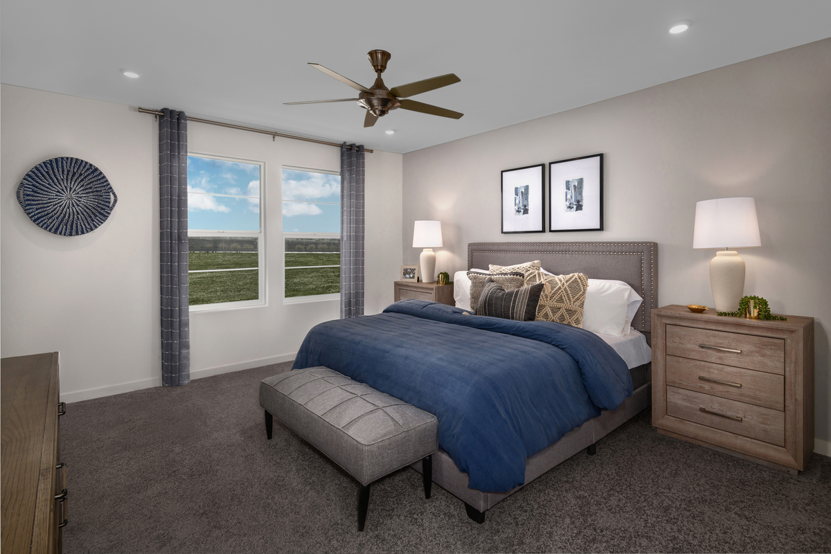 furnished primary bedroom with windows