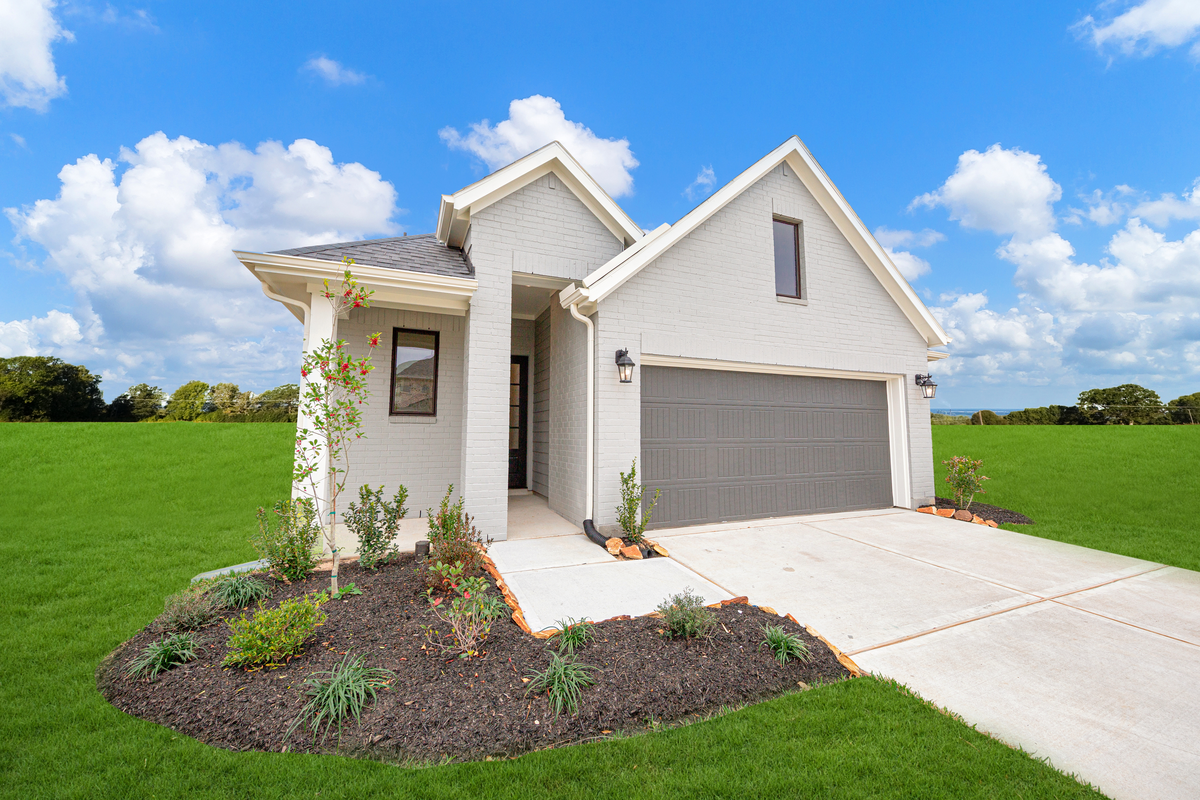 exterior brick home with gray garage door