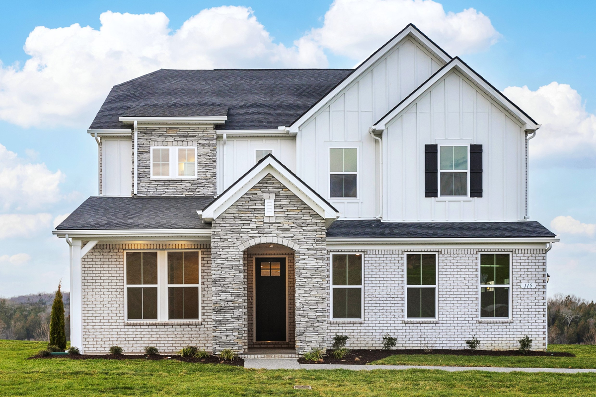 home exterior with brick and a covered porch