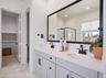 primary bathroom with neutral floors and white countertops
