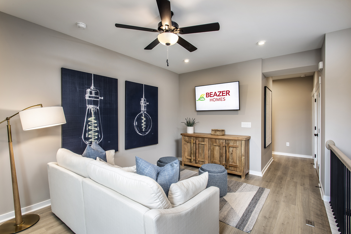 loft with hard-surface flooring, couch, & tv