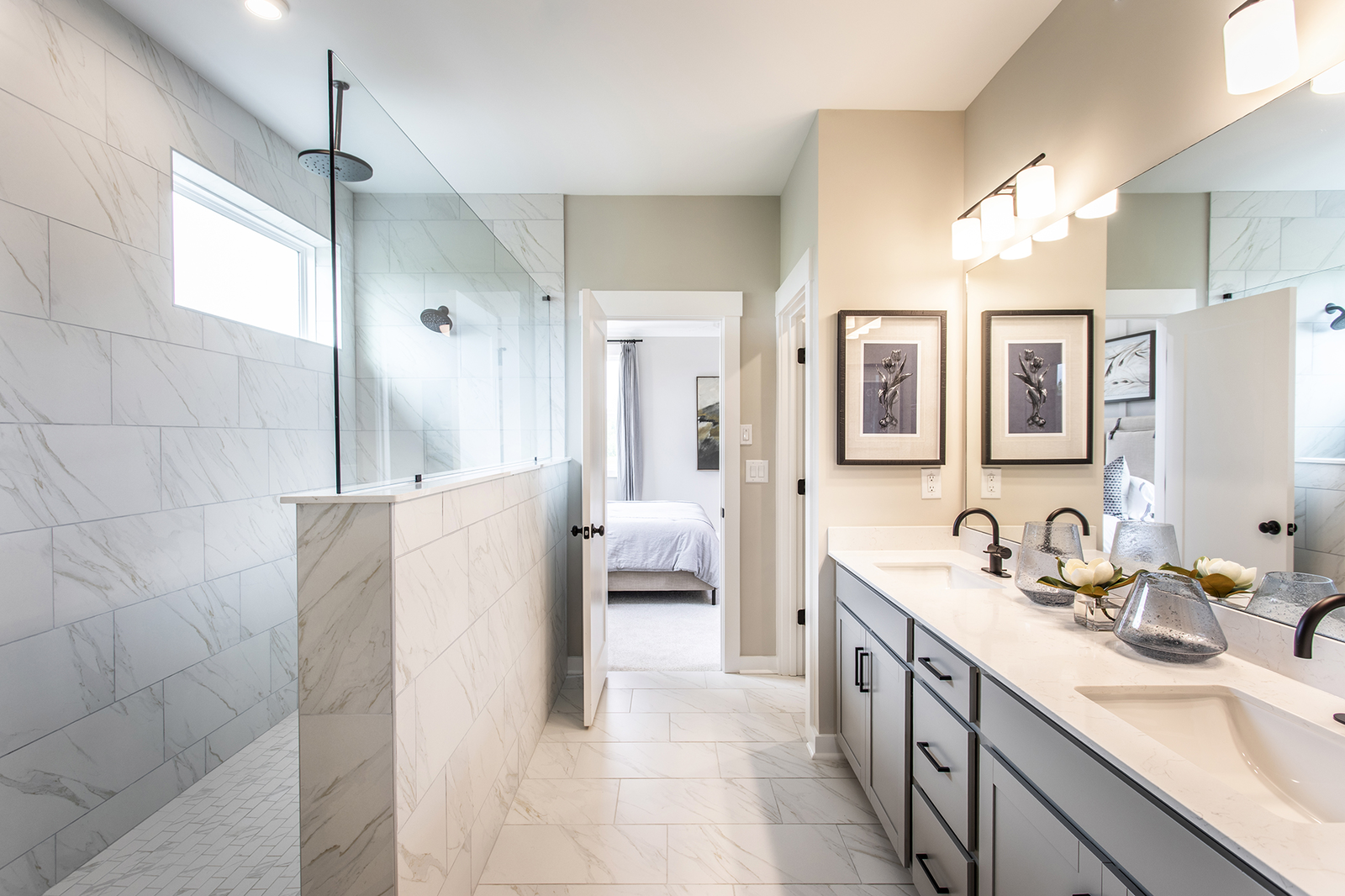 primary bathroom with dual vanity & gray cabinets