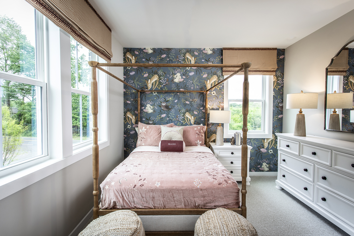 secondary bedroom with windows and carpet