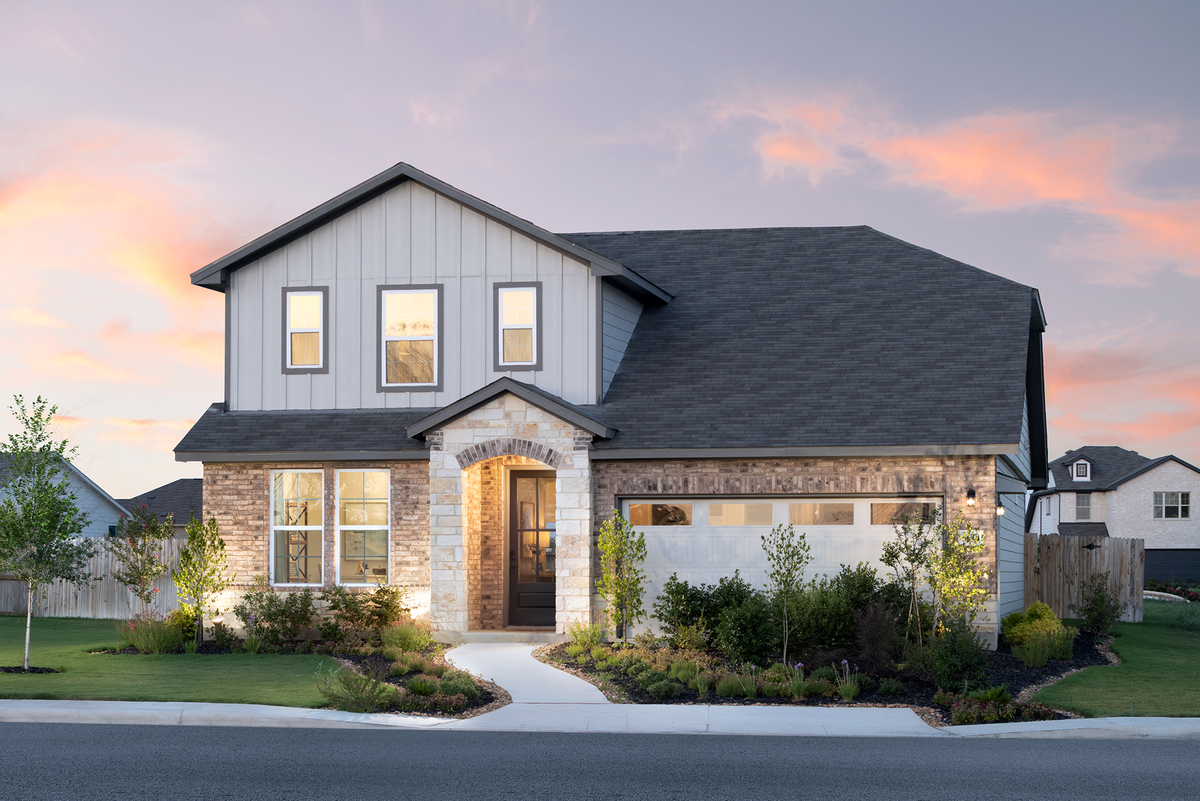 exterior with brick & stone with grass & sidewalk
