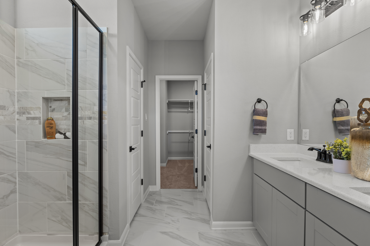 bathroom with granite counters & white cabinets 