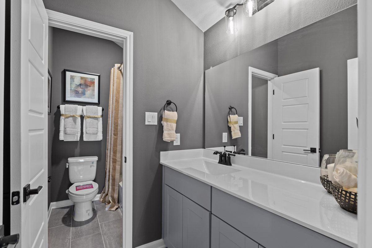 bathroom with gray cabinets & white countertop