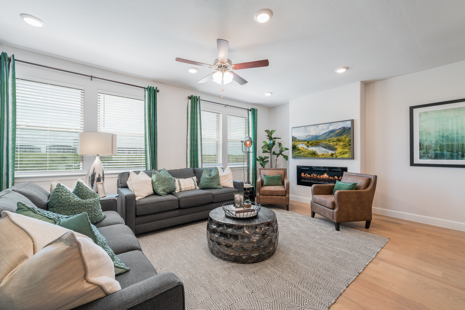 great room with gray couches and leather armchairs