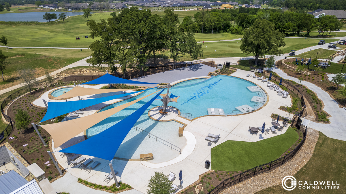 pool with sitting lounge areas, trees and walkways