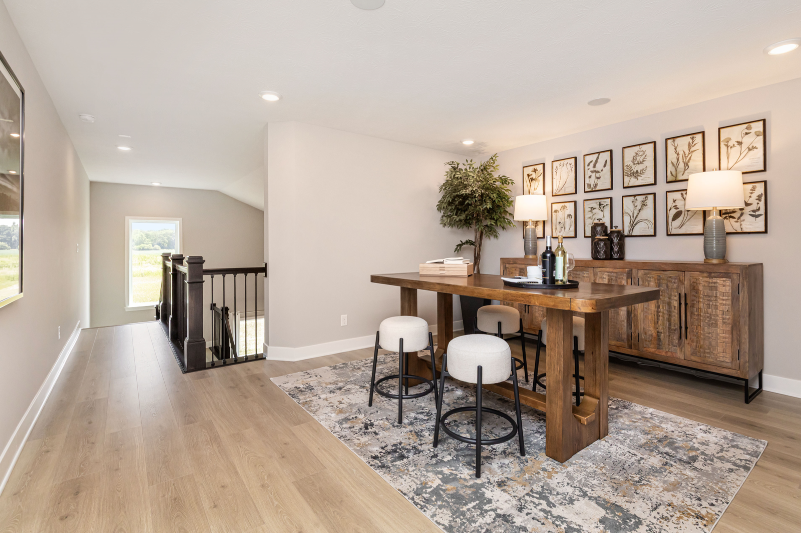 loft with wooden table, modern cushioned stools and abstract art