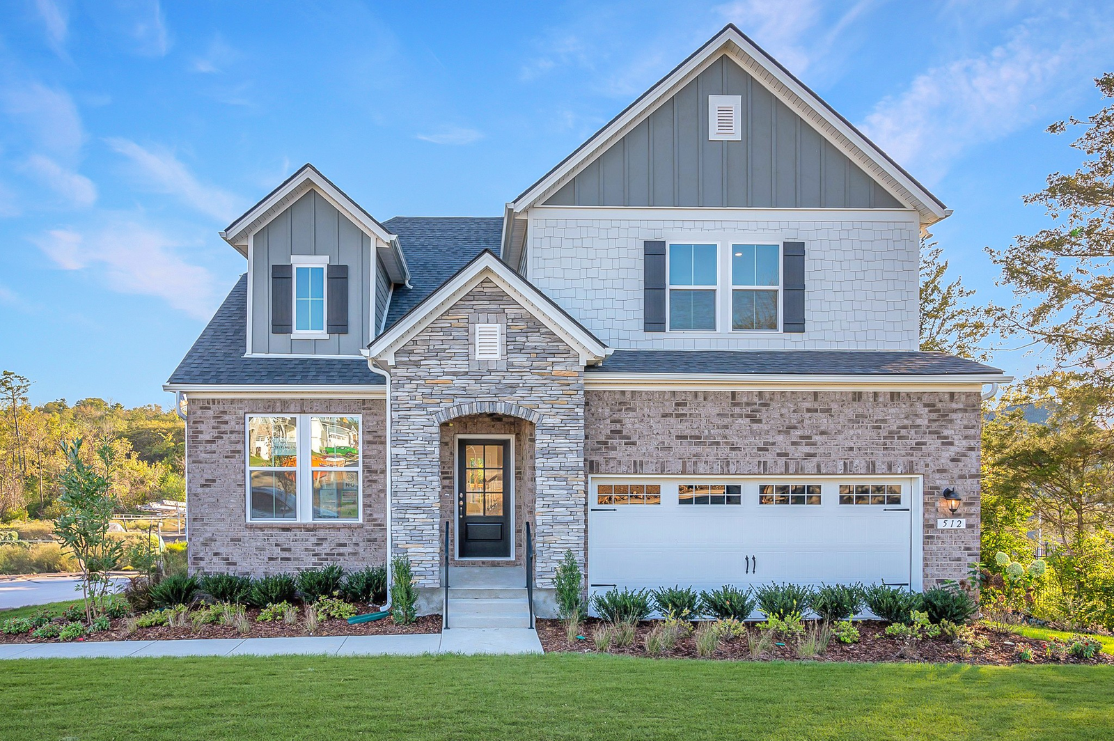 front exterior of home with stone entry and garage