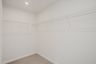 large walk-in closet with carpet and built in shelves