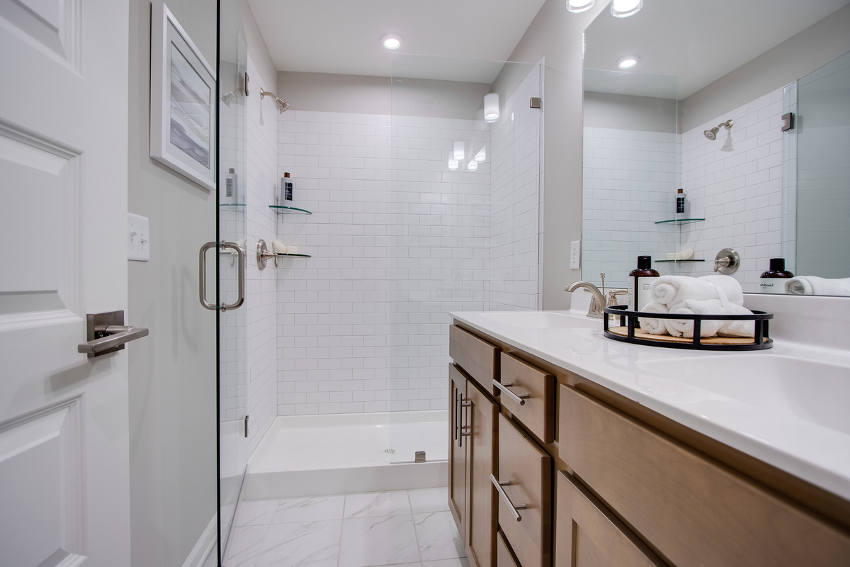 bathroom vanity with tile shower in the back