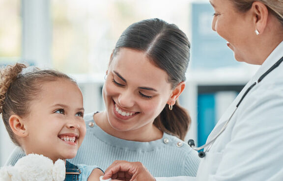 Child Shot of a doctor using a cotton ball on a littlean injection in a clinic
