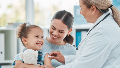 Child Shot of a doctor using a cotton ball on a littlean injection in a clinic