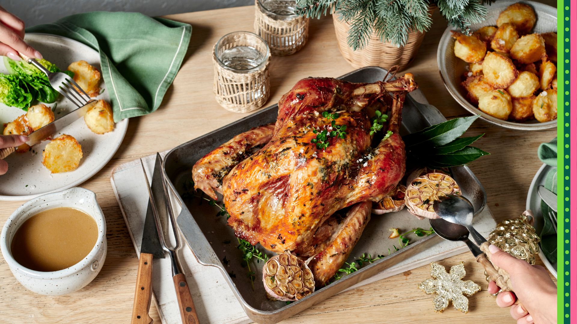 Classic Christmas roast turkey on a platter with herbs and garnished with vegetables.