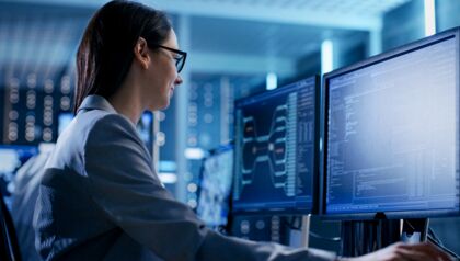 Woman working at a computer in a server room