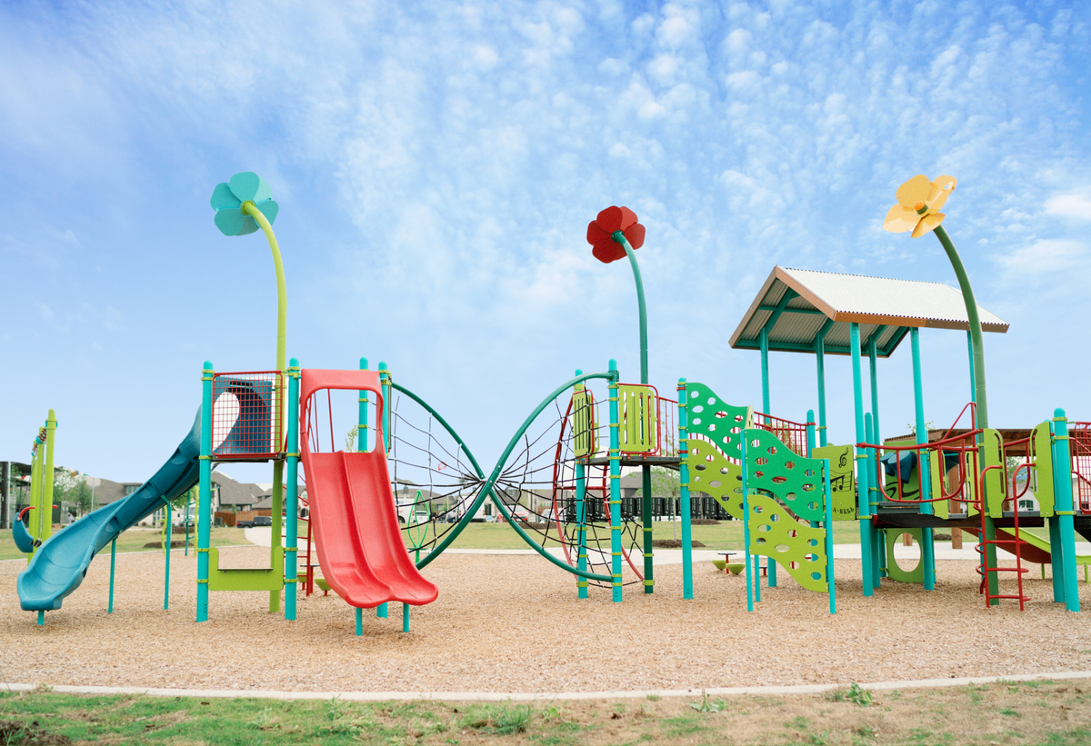 playground with a slide and climbing wall