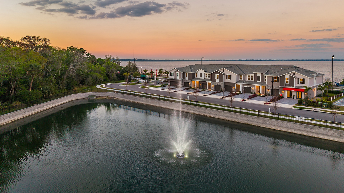 exterior of townhome building with sunset