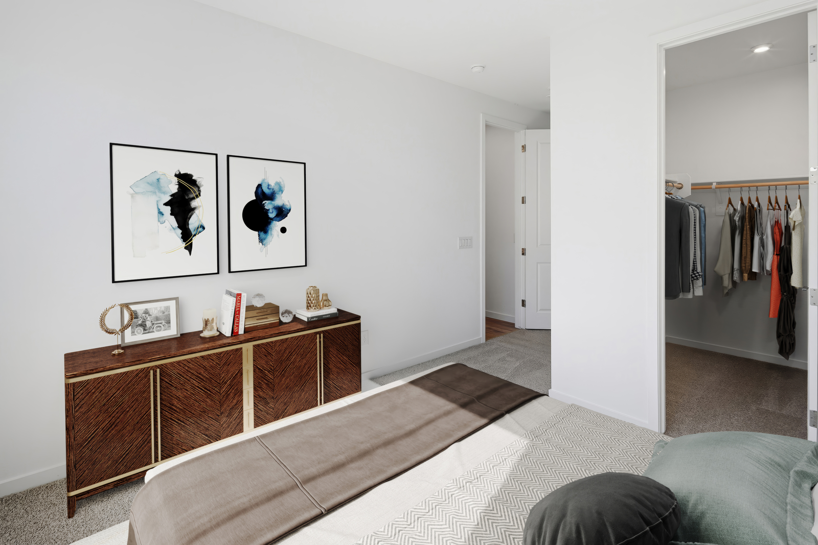 bedroom with a brown wooden dresser, a walk-in closet, and a spacious bed