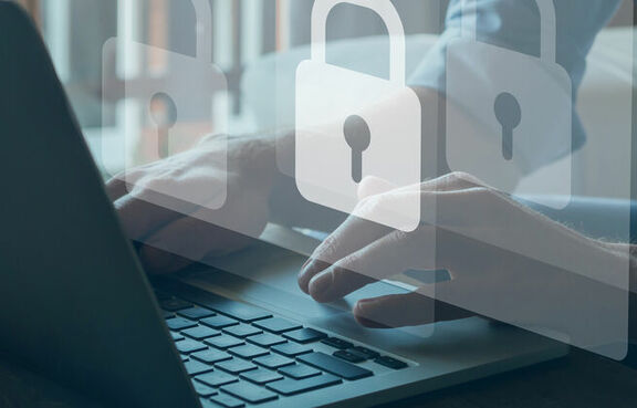 Laptop on a desktop with the icon of a padlock on the screen