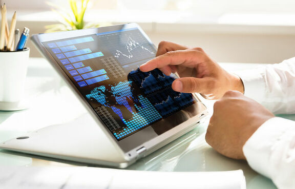 Person using a tablet to look at a dashboard of metrics