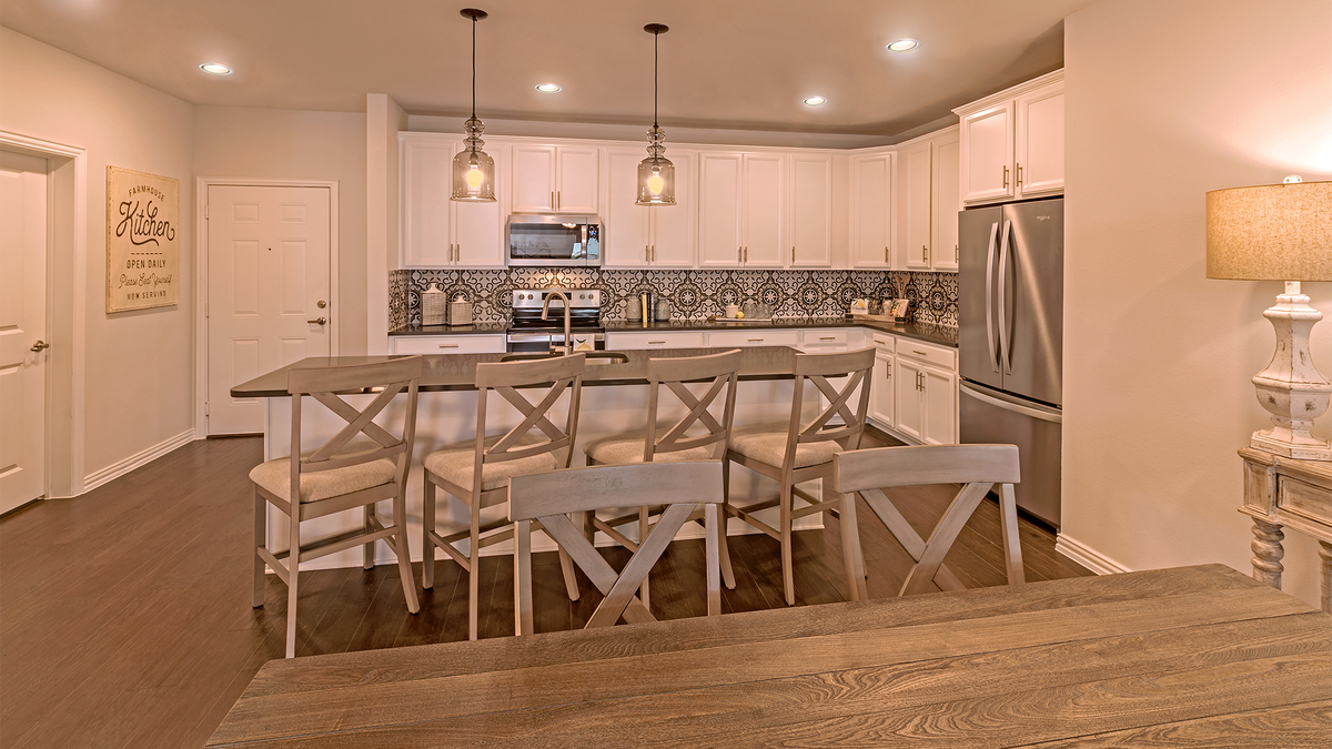 open kitchen with large island and wood floors