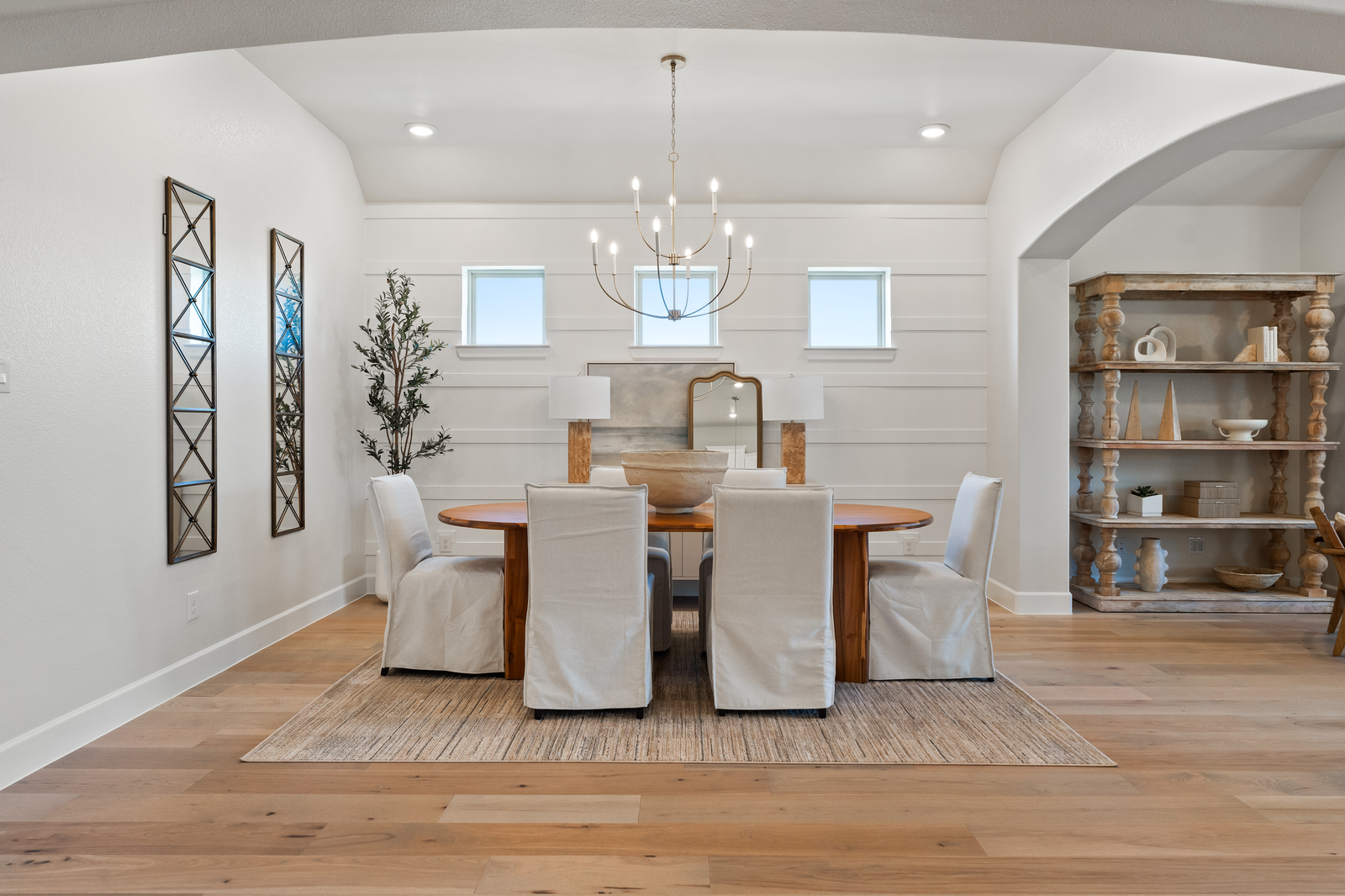 open dining room with wood floors and windows