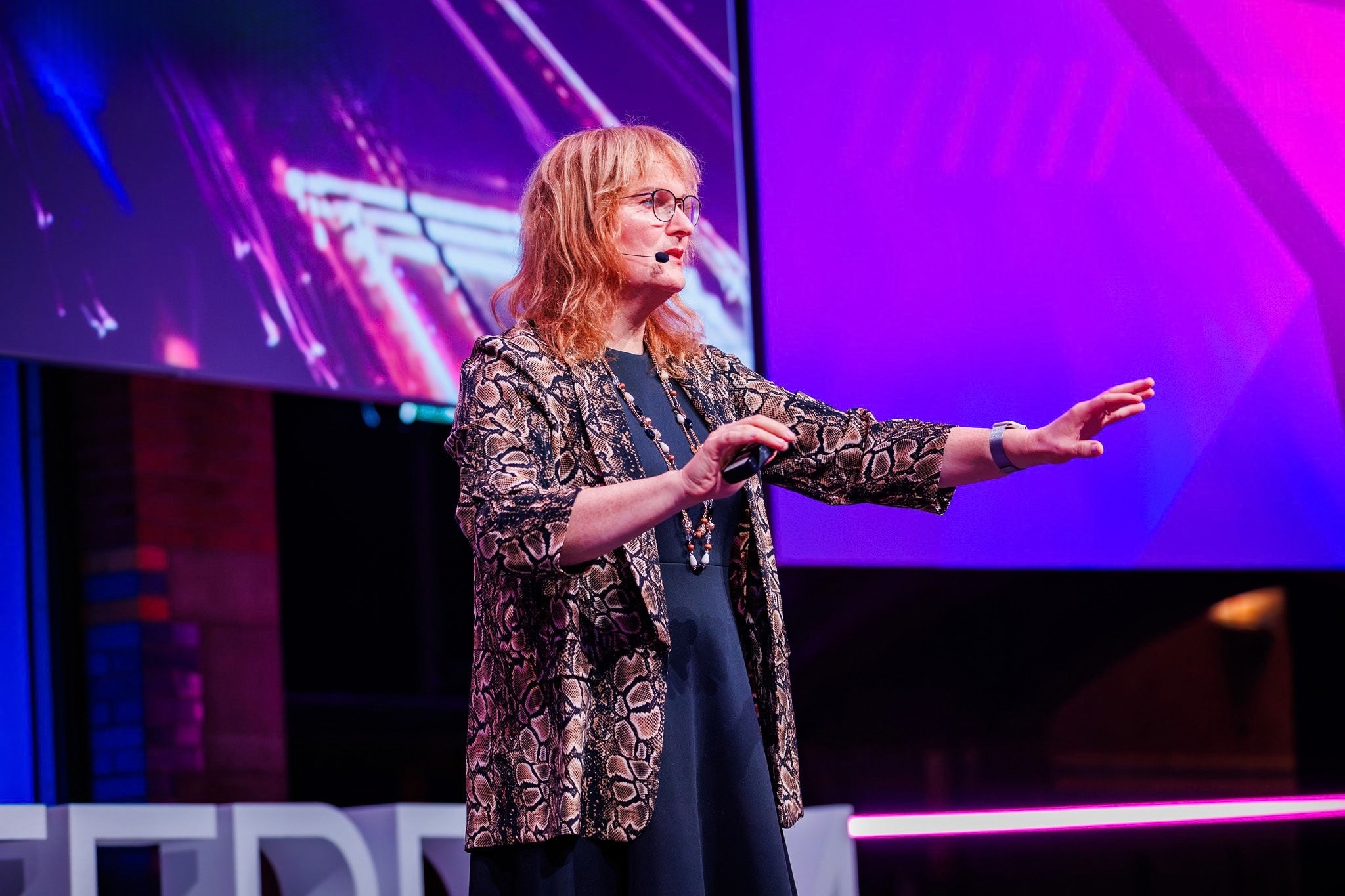 Woman with mic on stage