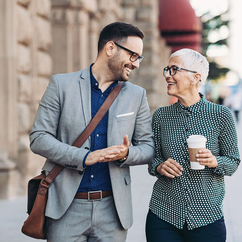 Man and woman wearing glasses chatting outside