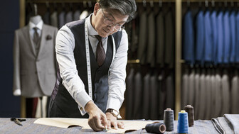 Tailor with glasses at work